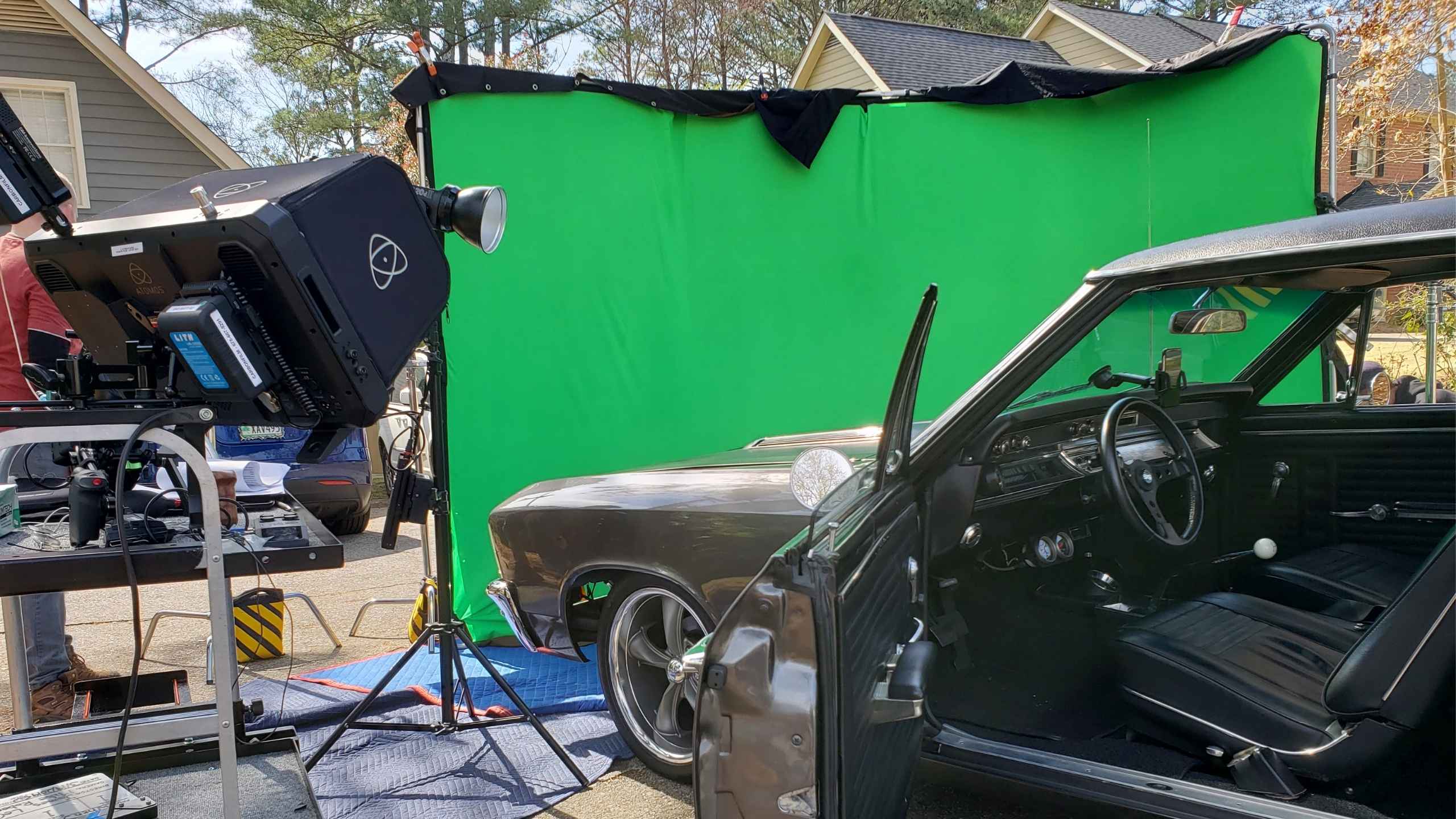 Behind the scenes of a car shoot on the green screen stage