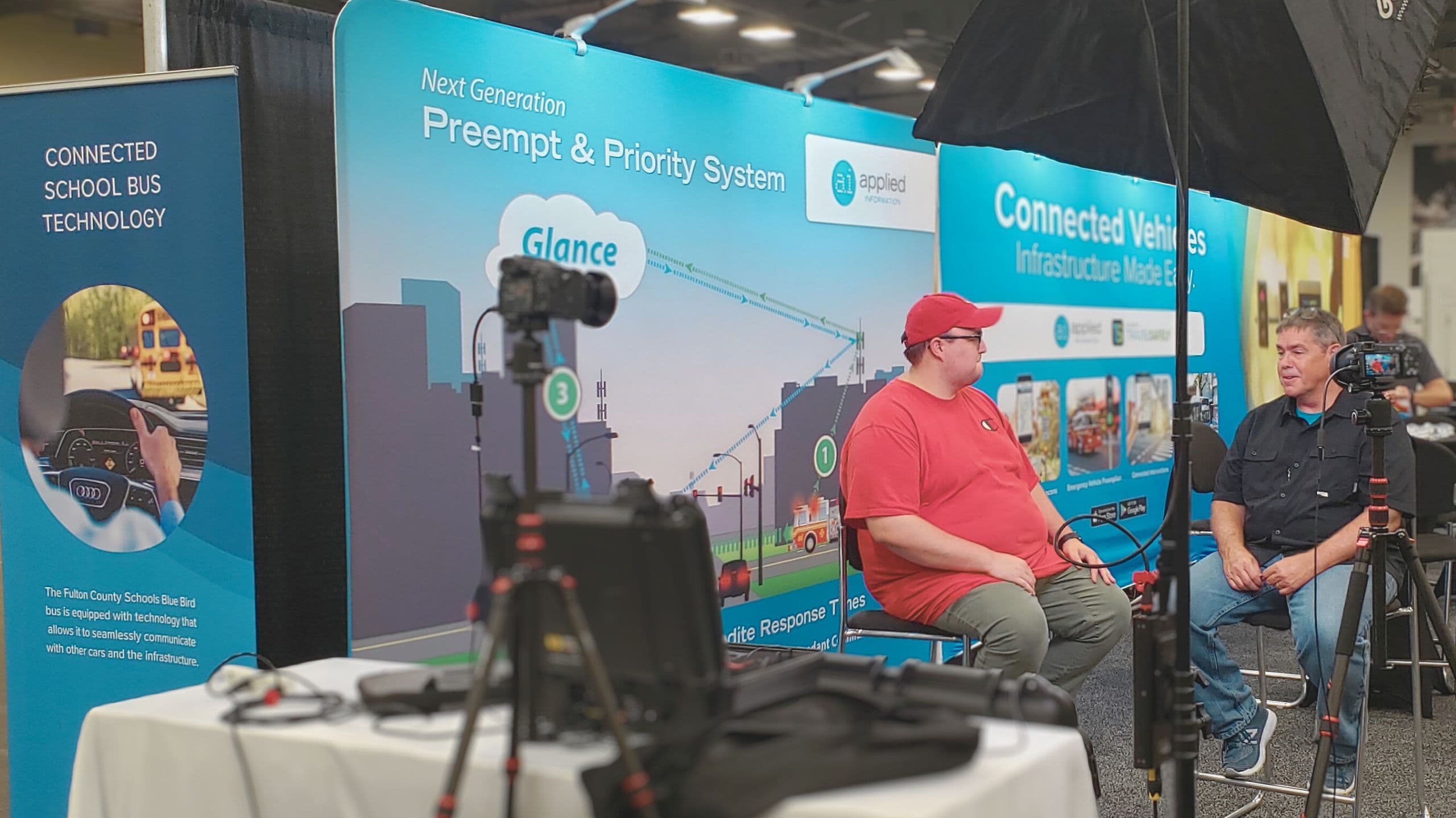 A videographer filming a speaker at a conference