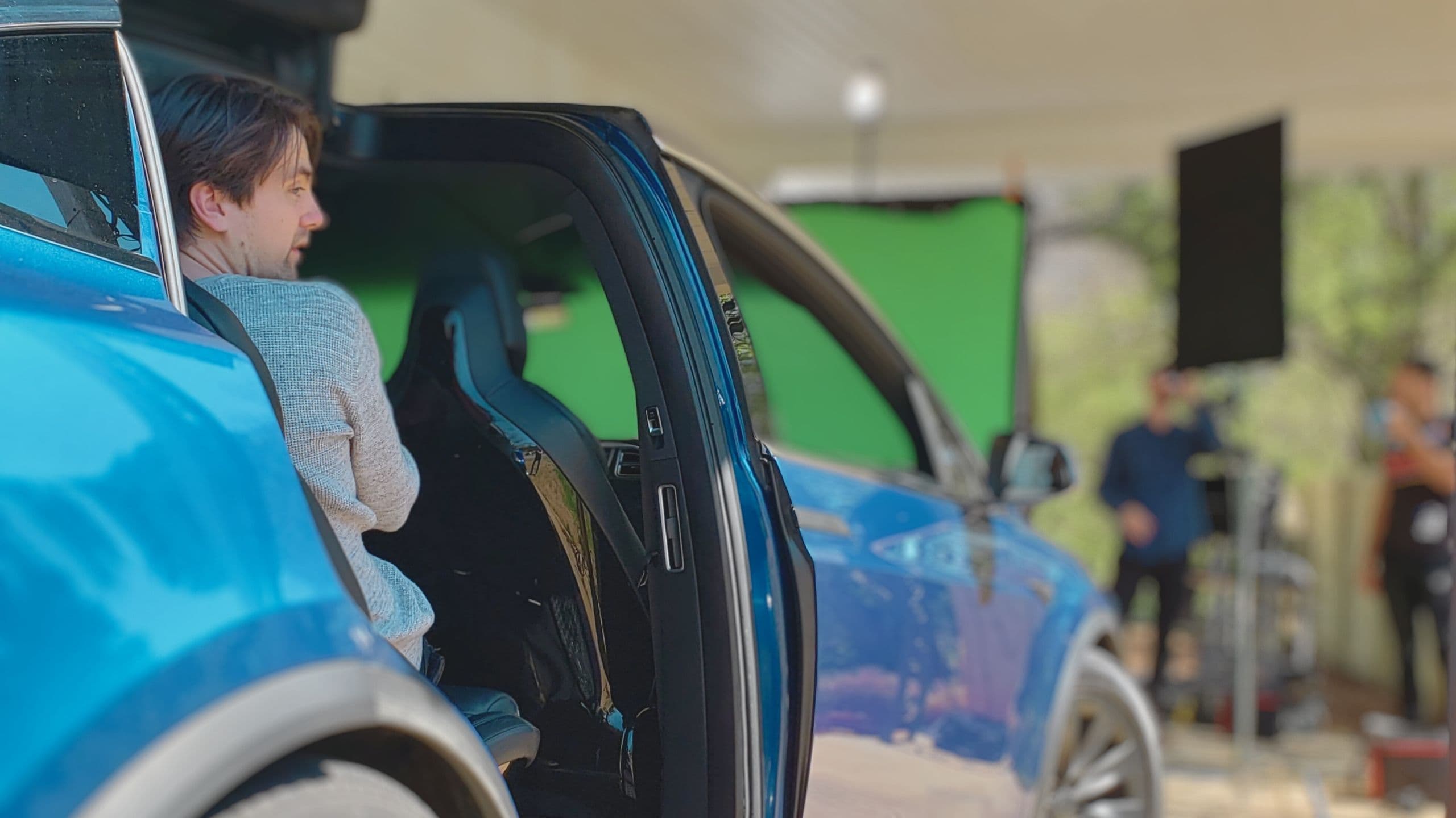 Mike filming a Tesla on a film set